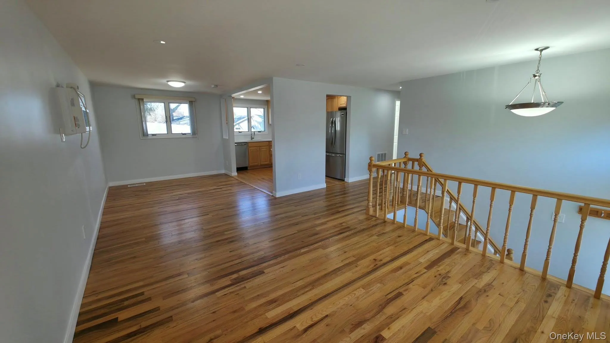 Empty room featuring wood finished floors and baseboards Empty room featuring wood finished floors and baseboards