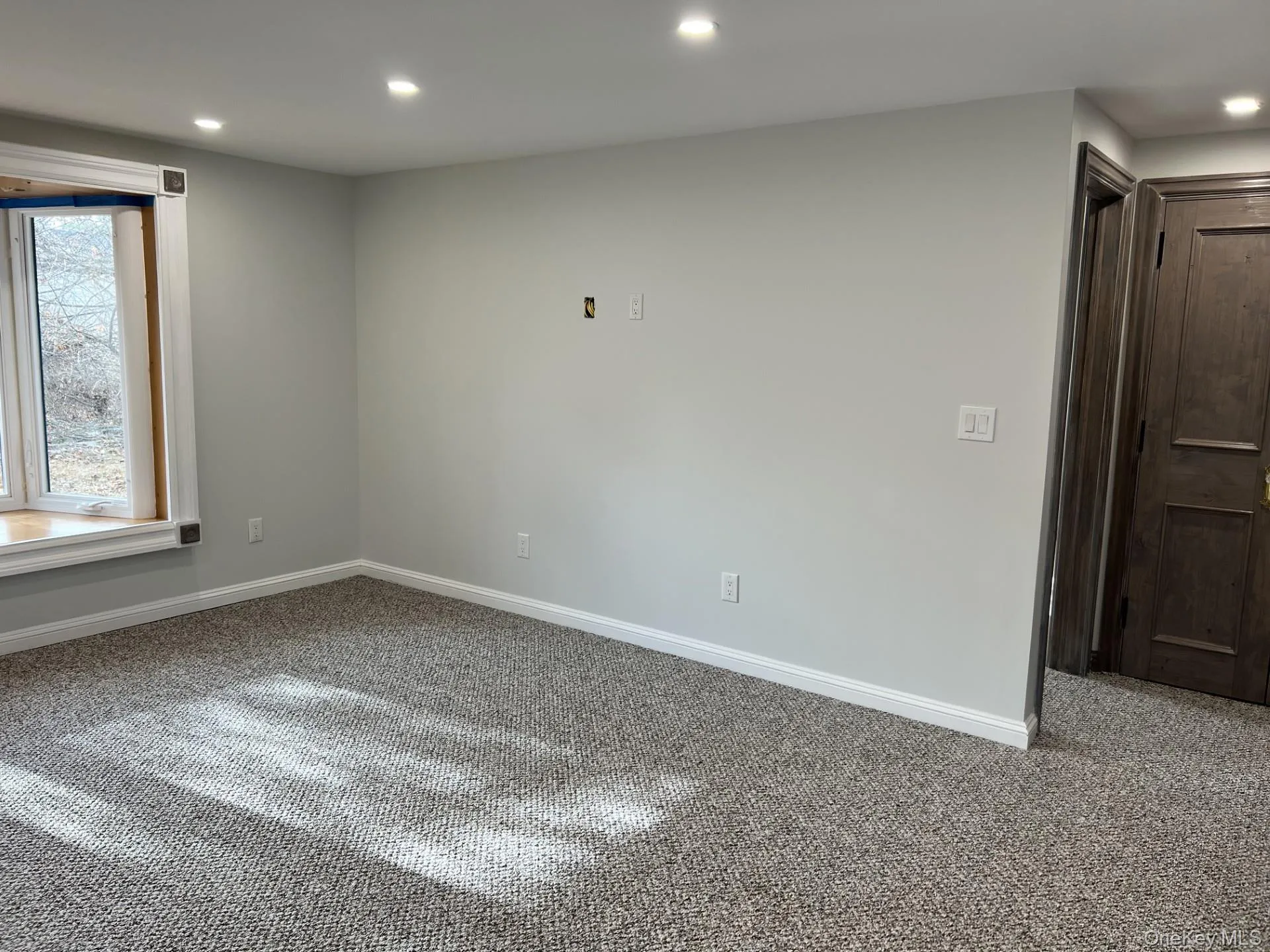 Carpeted spare room with recessed lighting and baseboards Carpeted spare room with recessed lighting and baseboards