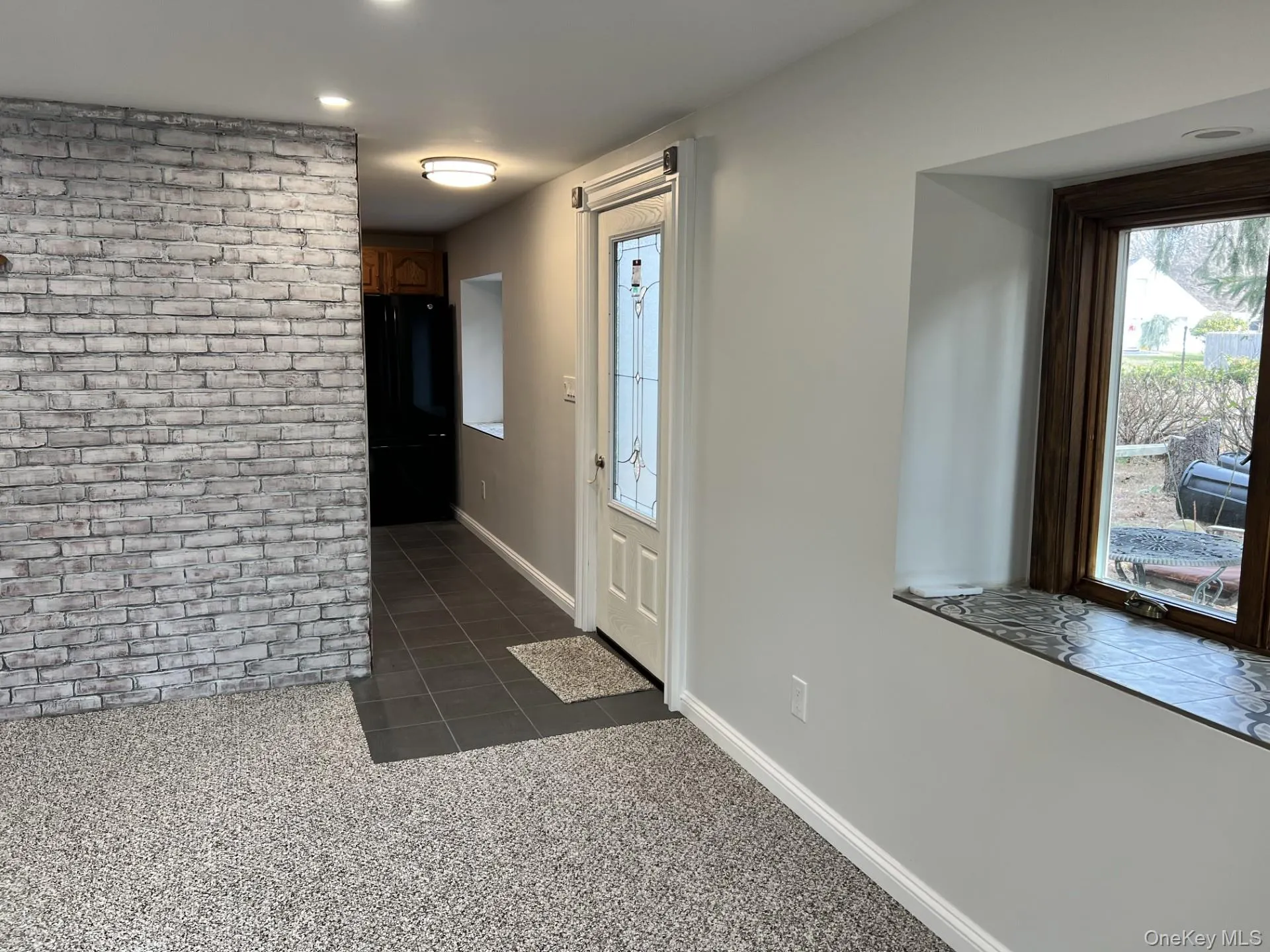 Foyer with dark colored carpet, dark tile patterned flooring, and recessed lighting Foyer with dark colored carpet, dark tile patterned flooring, and recessed lighting