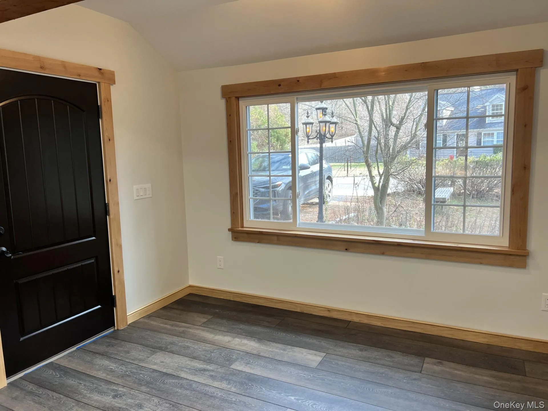 Entryway featuring hardwood / wood-style flooring, a chandelier, and lofted ceiling Entryway featuring hardwood / wood-style flooring, a chandelier, and lofted ceiling