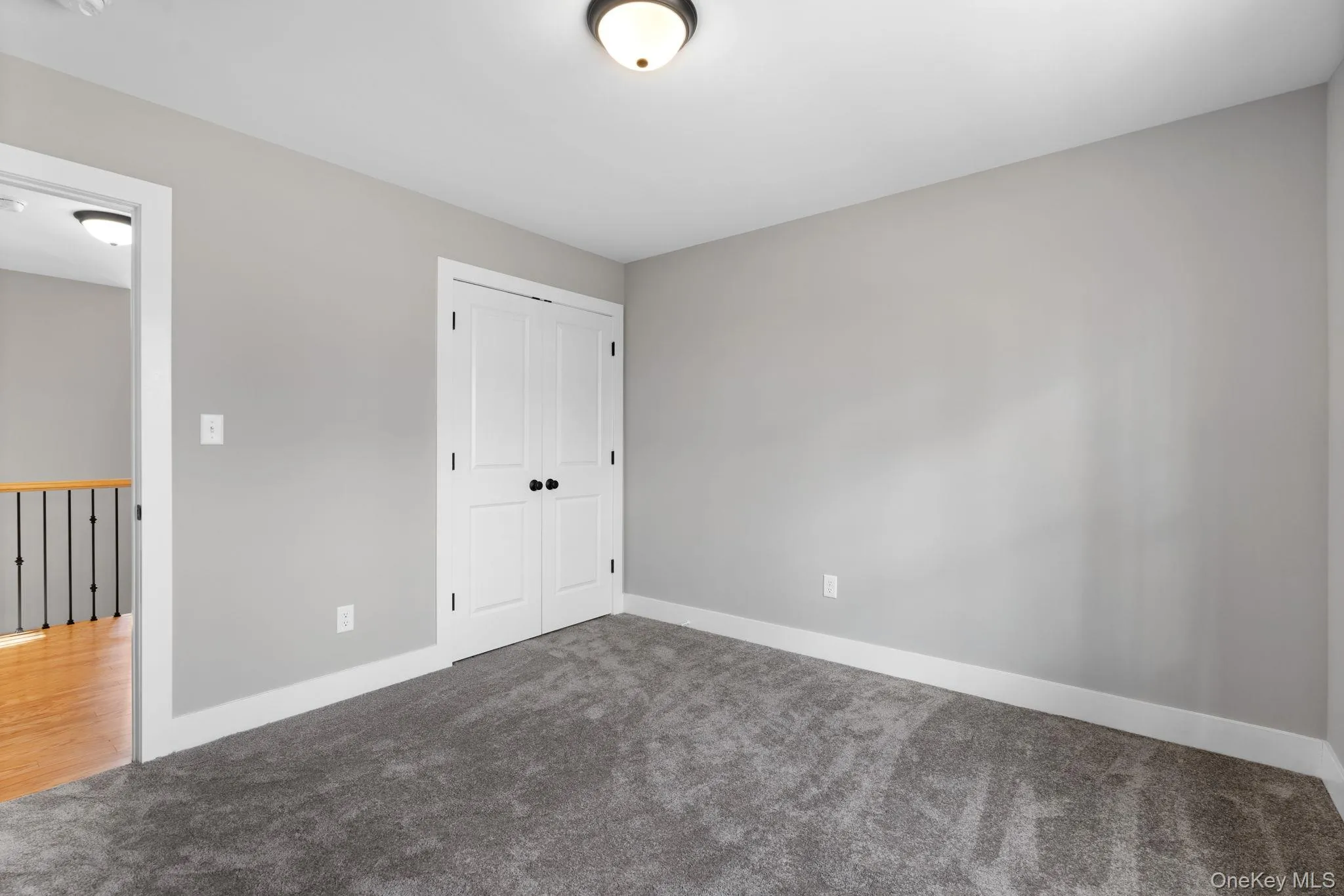 Unfurnished bedroom with carpet and a closet Unfurnished bedroom with carpet and a closet