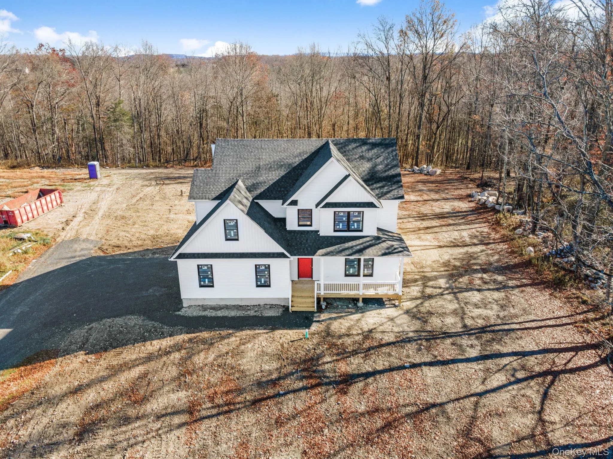 View of front of property featuring roof with shingles and a view of trees View of front of property featuring roof with shingles and a view of trees