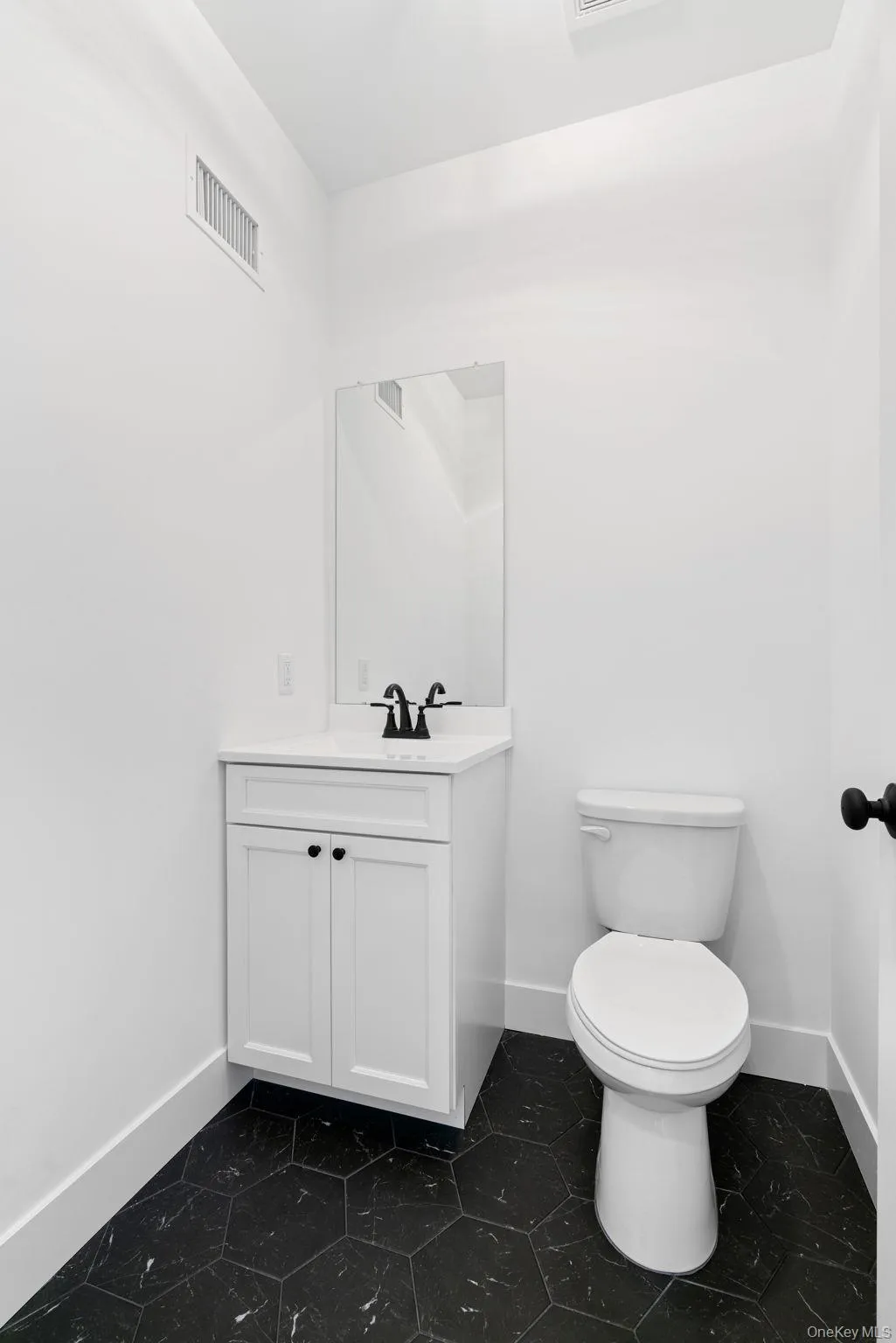 Bathroom featuring vanity and baseboards Bathroom featuring vanity and baseboards