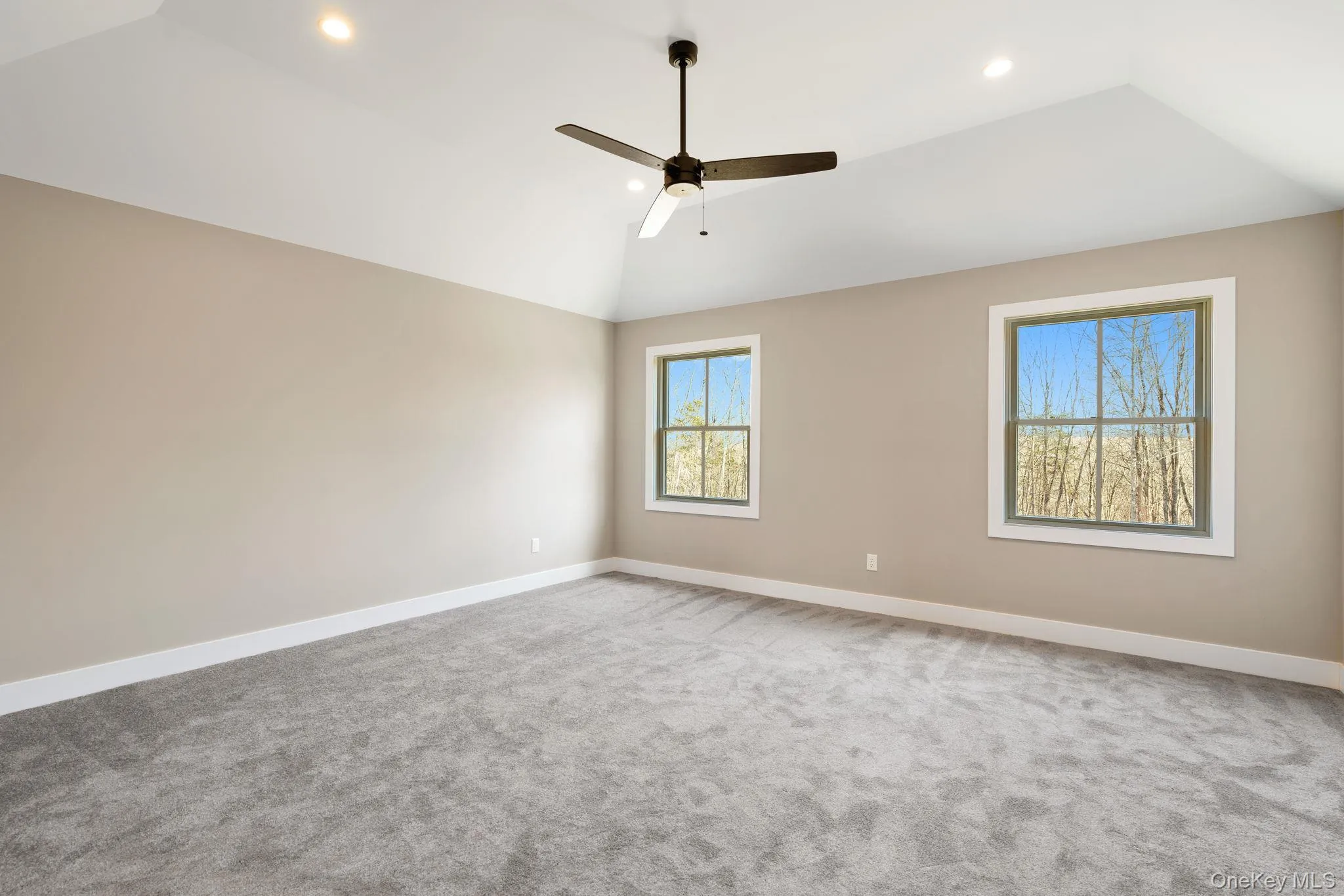 Spare room with vaulted ceiling, a ceiling fan, light carpet, and recessed lighting Spare room with vaulted ceiling, a ceiling fan, light carpet, and recessed lighting
