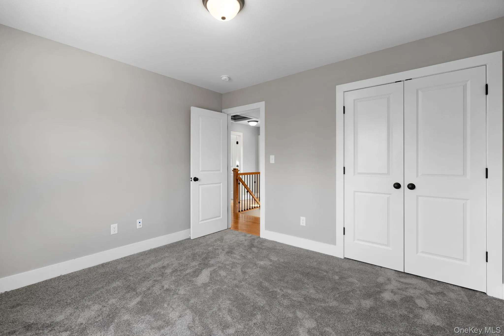 Unfurnished bedroom with carpet and a closet Unfurnished bedroom with carpet and a closet