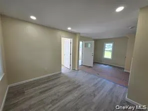 Spare room featuring recessed lighting and dark wood-style flooring Spare room featuring recessed lighting and dark wood-style flooring