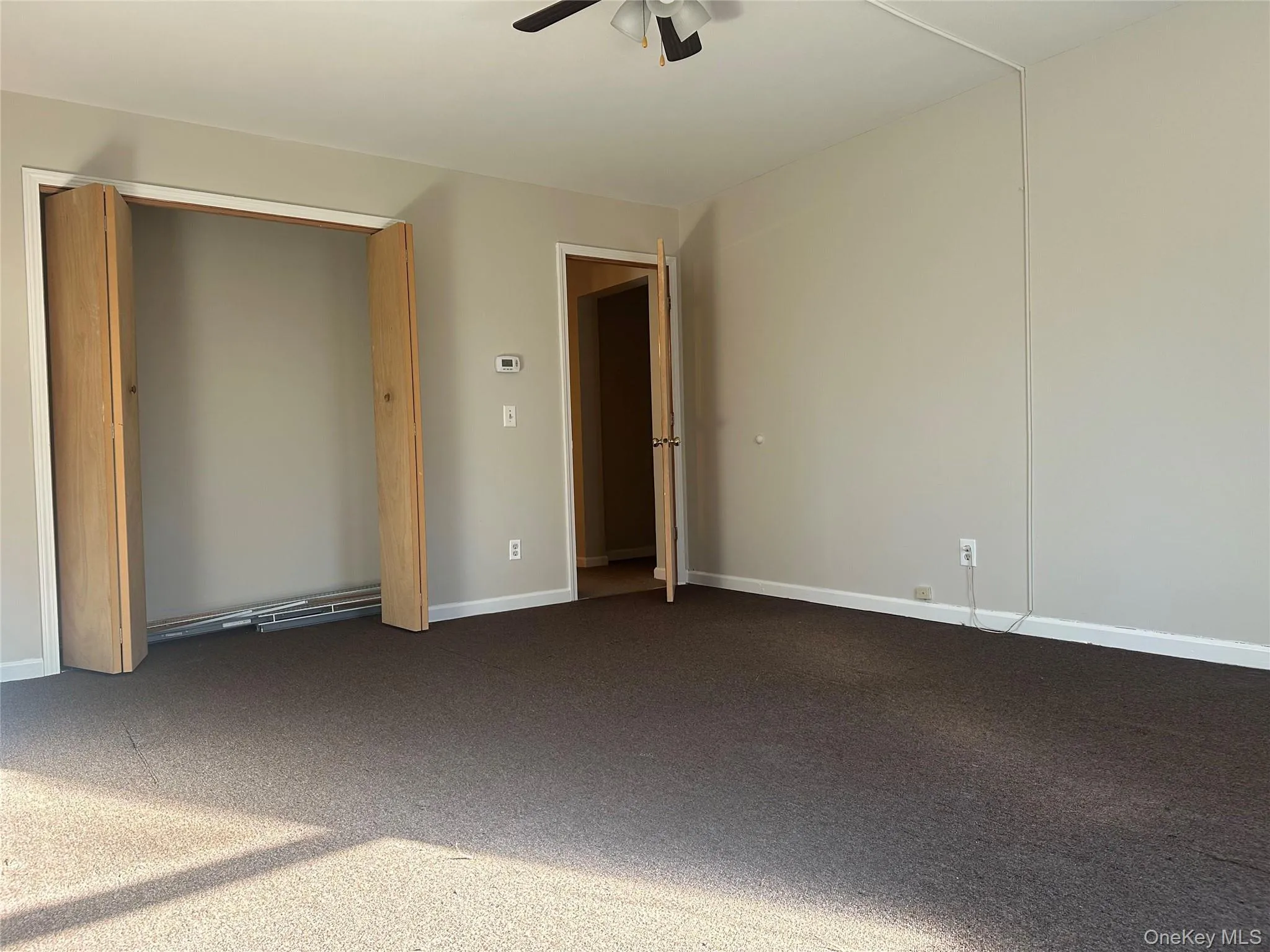 Unfurnished bedroom featuring carpet floors and ceiling fan Unfurnished bedroom featuring carpet floors and ceiling fan