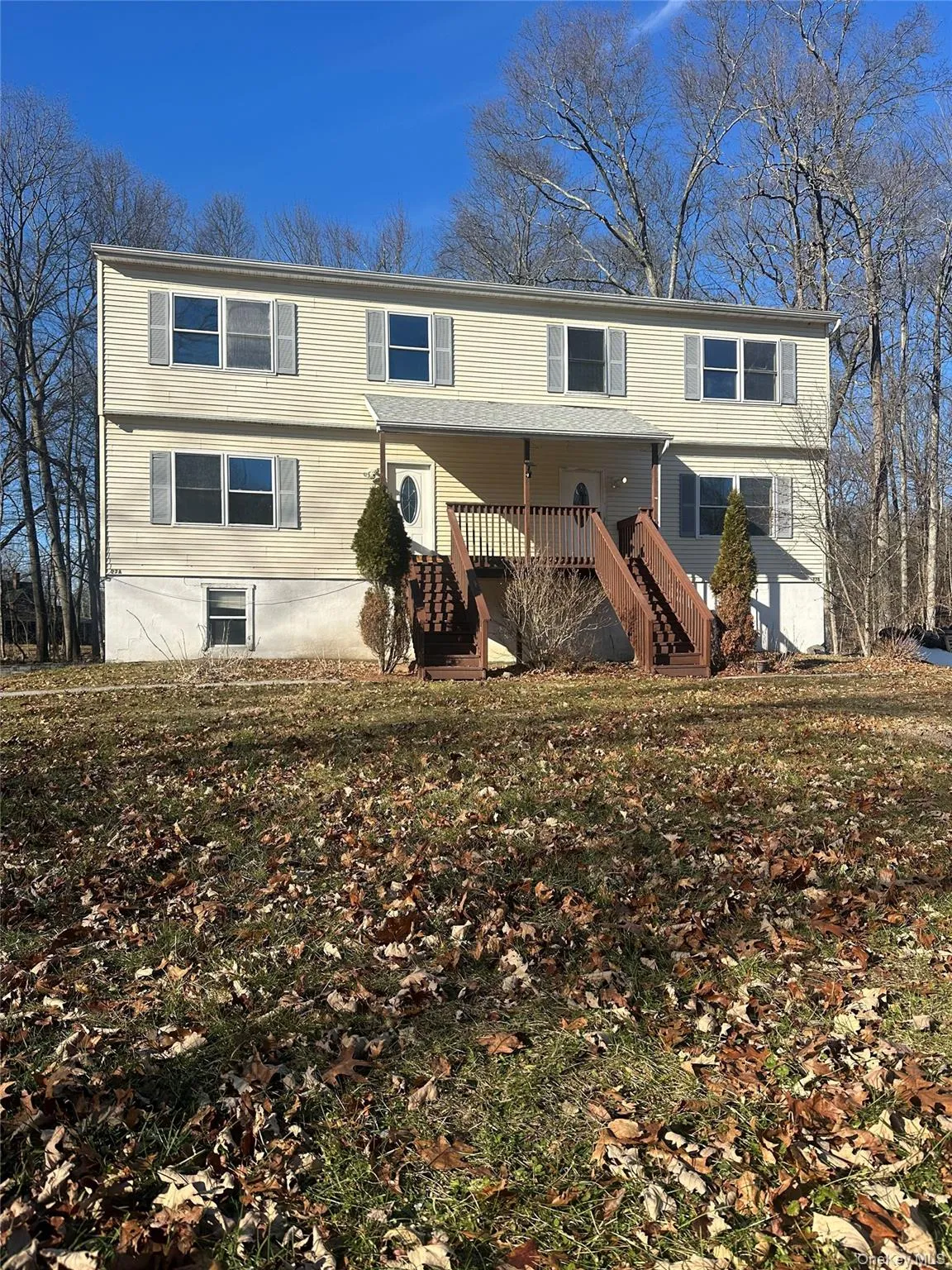 Rear view of property featuring stairway and a yard Rear view of property featuring stairway and a yard