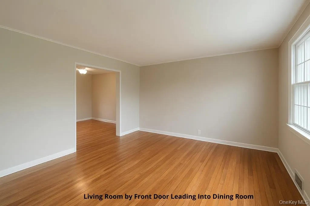 Spare room featuring light wood-type flooring and crown molding Spare room featuring light wood-type flooring and crown molding