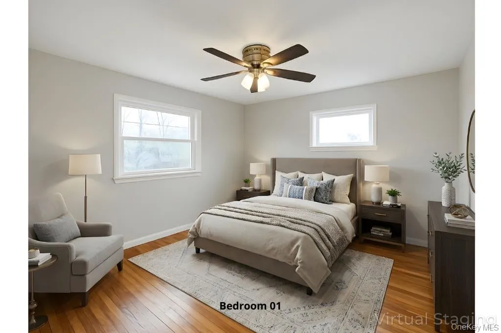 Bedroom featuring hardwood / wood-style flooring and a ceiling fan Bedroom featuring hardwood / wood-style flooring and a ceiling fan