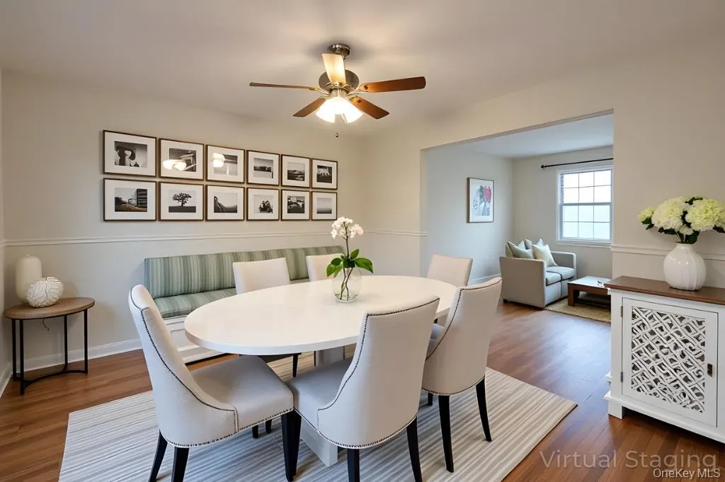 Dining room featuring dark wood finished floors and a ceiling fan Dining room featuring dark wood finished floors and a ceiling fan