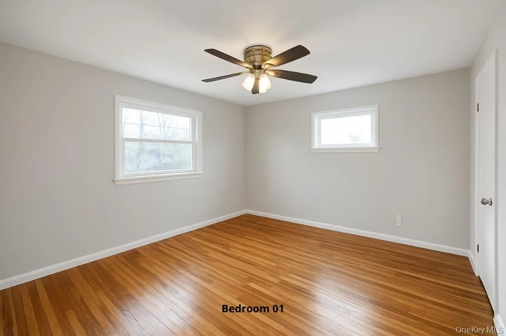 Empty room with wood-type flooring and ceiling fan Empty room with wood-type flooring and ceiling fan