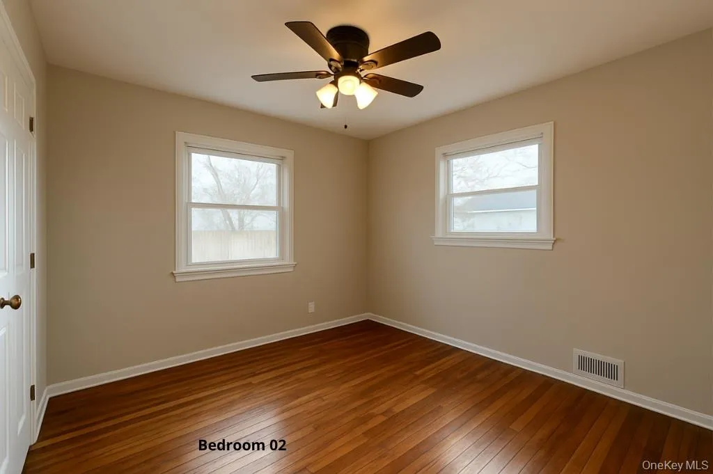 Unfurnished room featuring dark wood-style flooring, healthy amount of natural light, and ceiling fan Unfurnished room featuring dark wood-style flooring, healthy amount of natural light, and ceiling fan