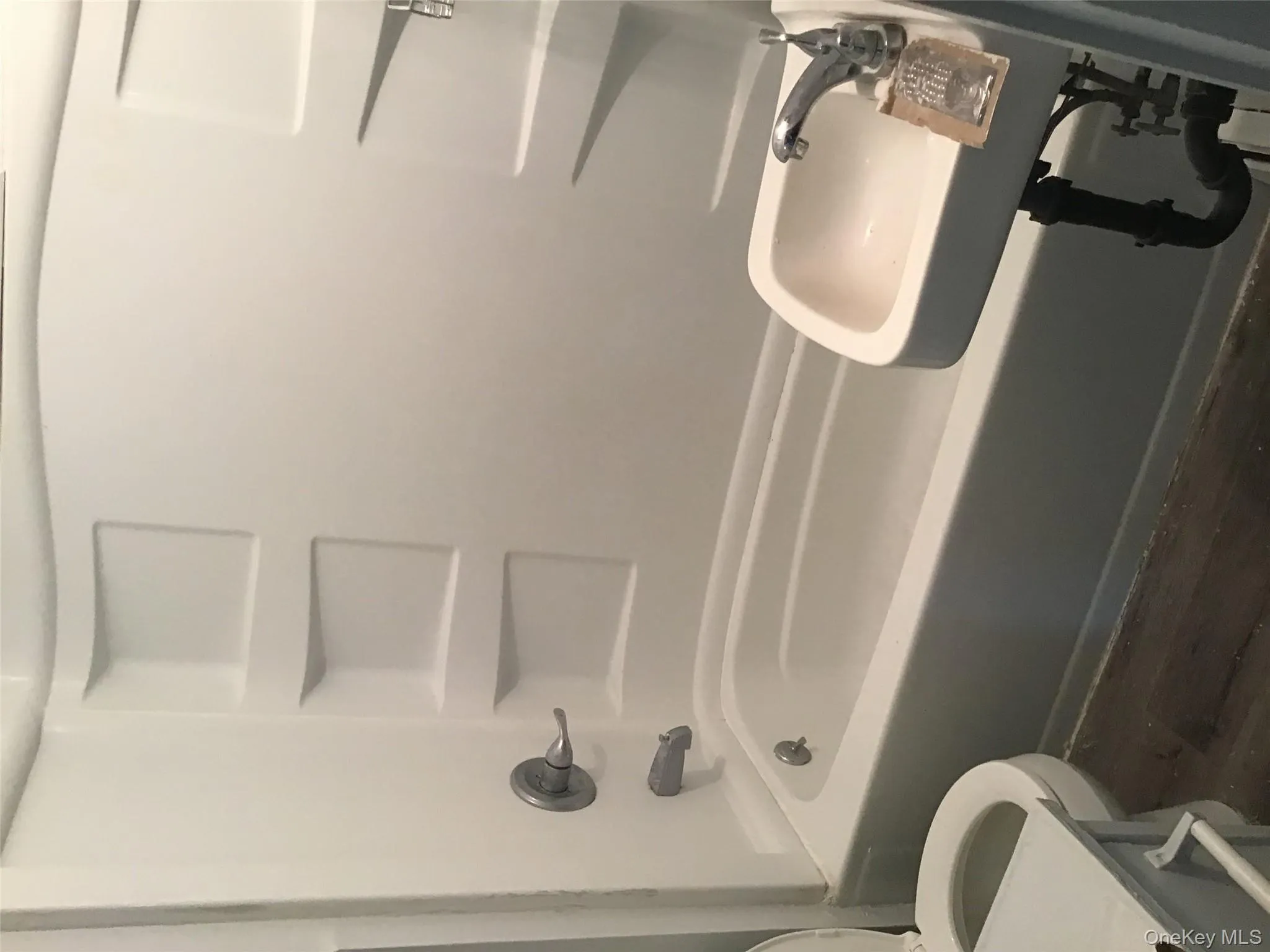 Bathroom featuring shower / washtub combination and dark wood-type flooring Bathroom featuring shower / washtub combination and dark wood-type flooring