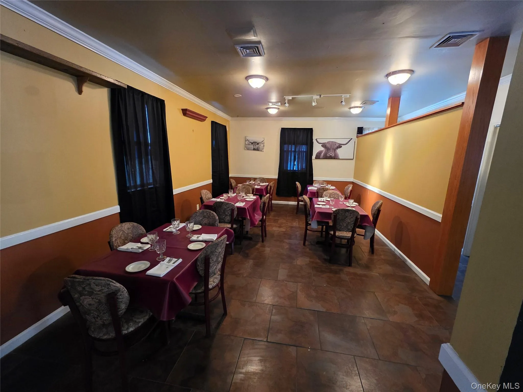 Dining area with baseboards and track lighting Dining area with baseboards and track lighting