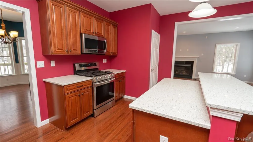 Kitchen with healthy amount of natural light, pendant lighting, appliances with stainless steel finishes, and a kitchen island Kitchen with healthy amount of natural light, pendant lighting, appliances with stainless steel finishes, and a kitchen island