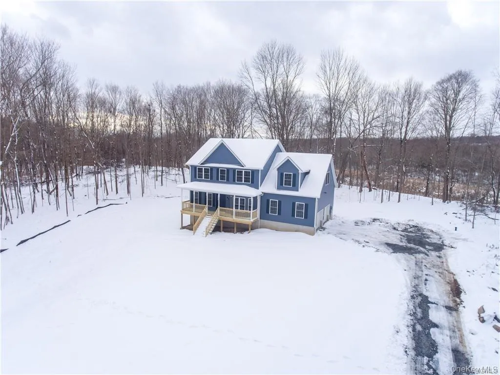 View of front of home featuring stairway and a wooden deck View of front of home featuring stairway and a wooden deck
