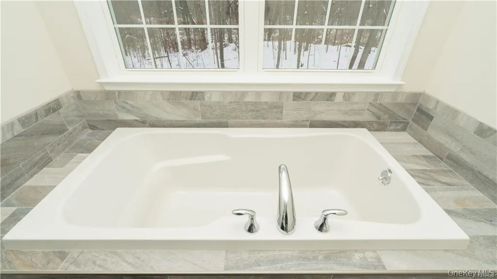 Bathroom featuring a bath Bathroom featuring a bath