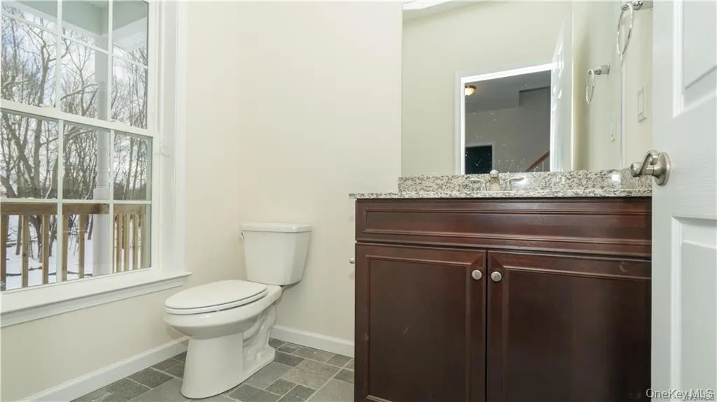 Bathroom featuring vanity and baseboards Bathroom featuring vanity and baseboards