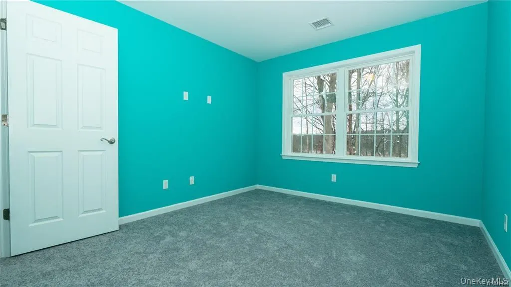 Unfurnished bedroom with baseboards and dark colored carpet Unfurnished bedroom with baseboards and dark colored carpet