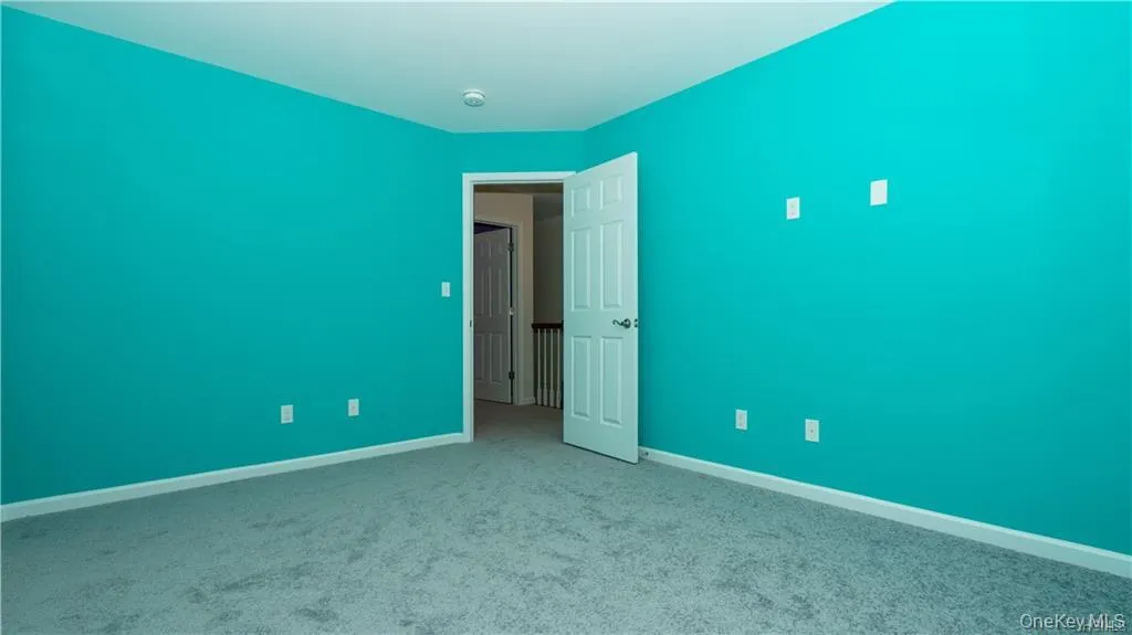 Spare room with baseboards and carpet flooring Spare room with baseboards and carpet flooring
