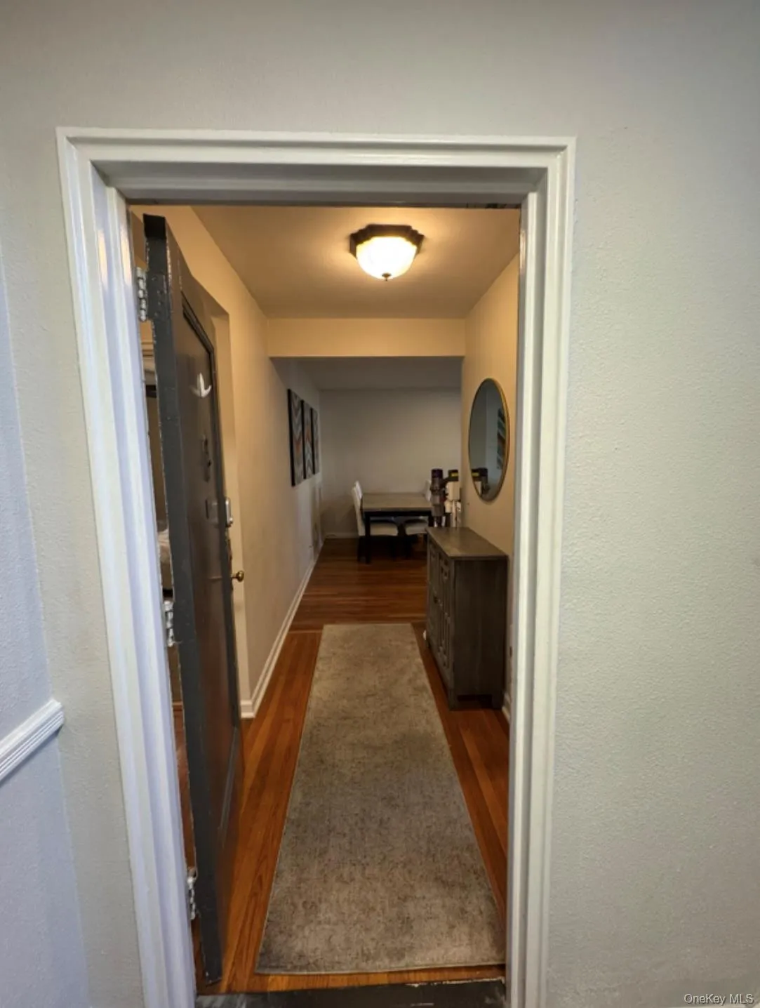 Corridor with dark wood-style floors and a textured wall Corridor with dark wood-style floors and a textured wall