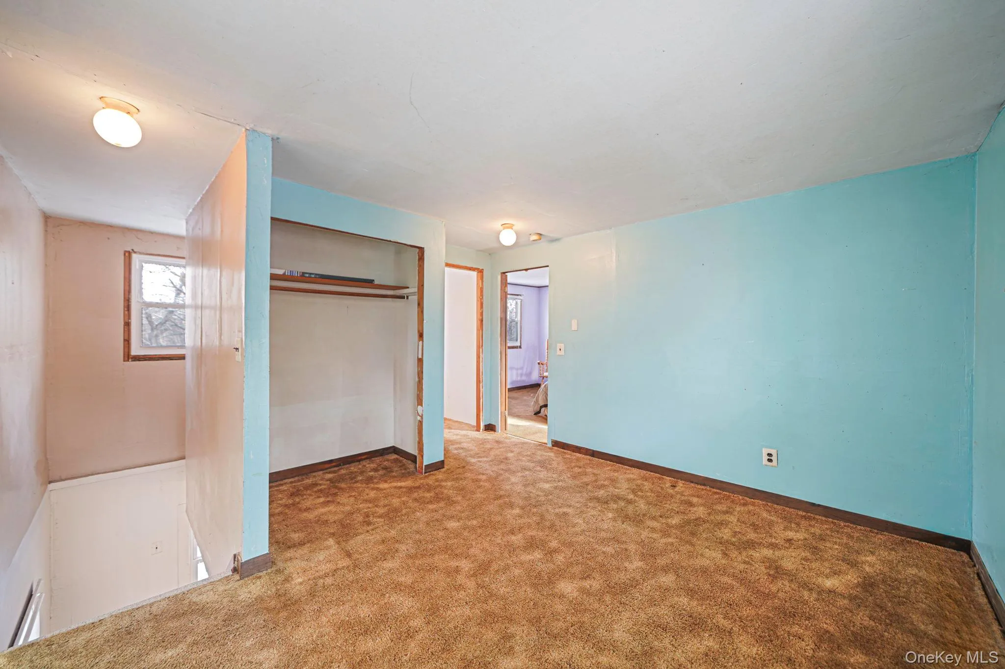 Unfurnished bedroom with a closet and carpet floors Unfurnished bedroom with a closet and carpet floors