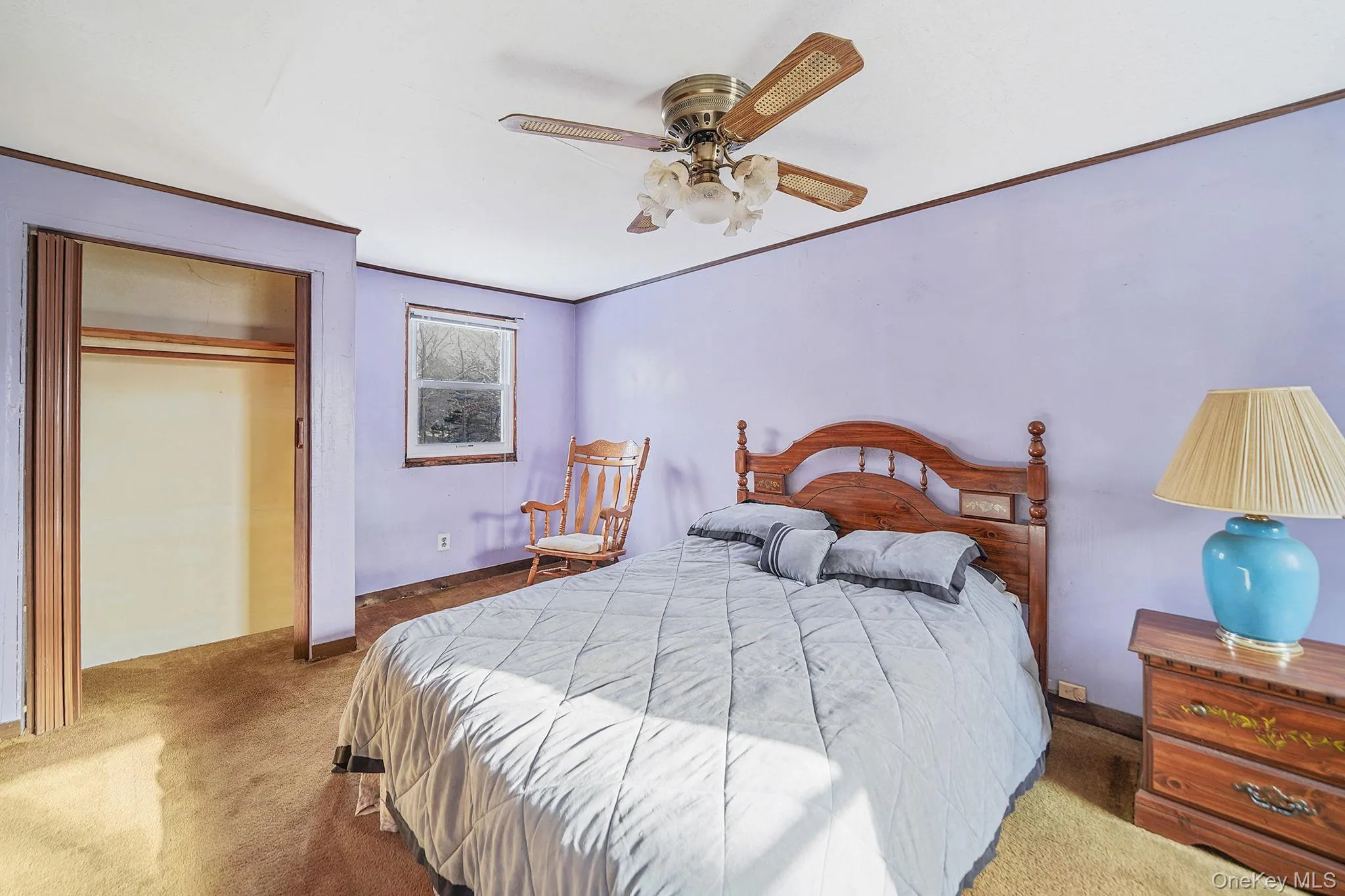 Bedroom featuring crown molding, carpet floors, a closet, and a ceiling fan Bedroom featuring crown molding, carpet floors, a closet, and a ceiling fan