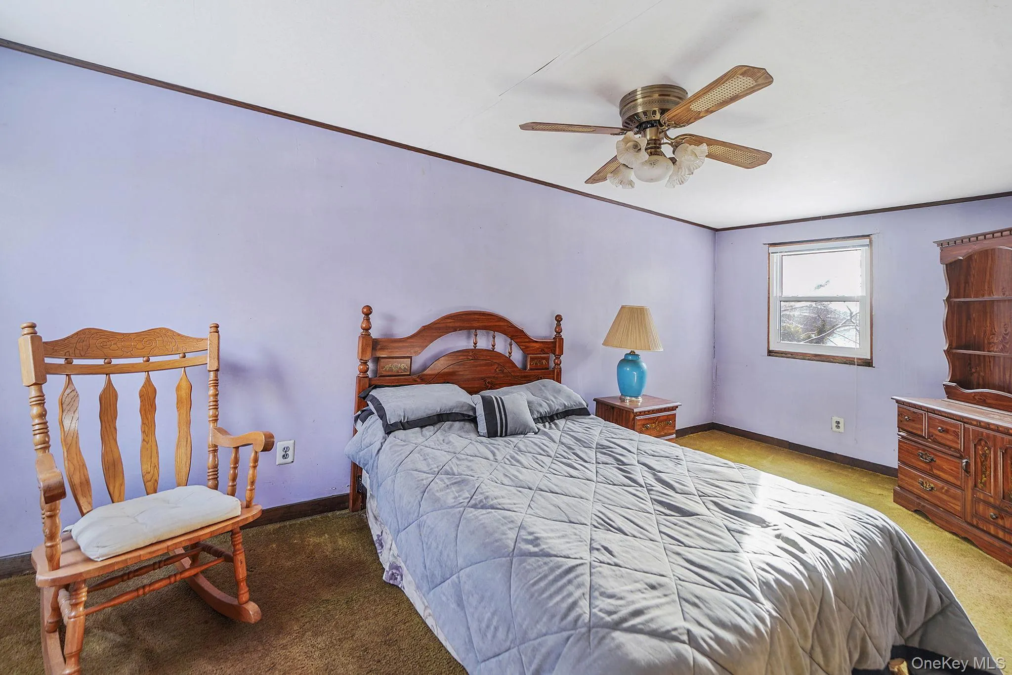 Bedroom featuring a ceiling fan, crown molding, and light colored carpet Bedroom featuring a ceiling fan, crown molding, and light colored carpet