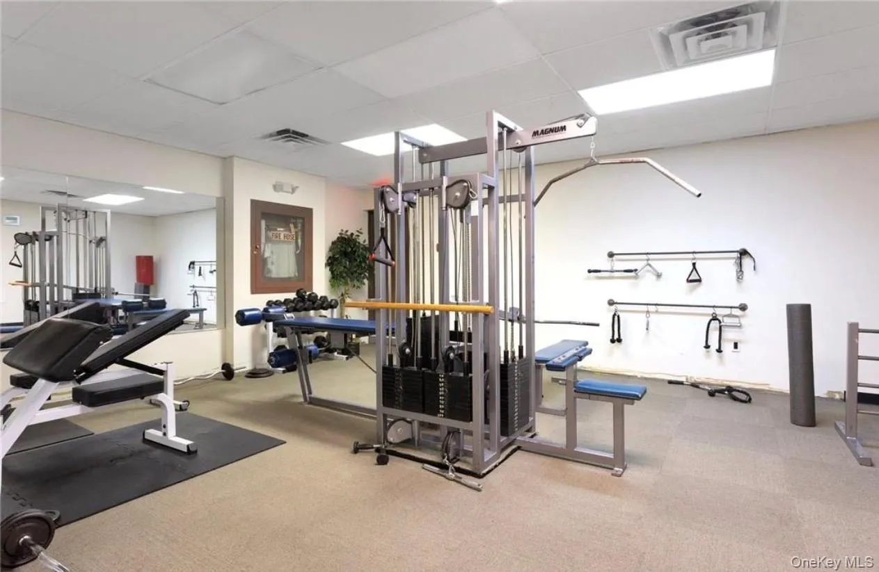 Gym featuring a paneled ceiling Gym featuring a paneled ceiling