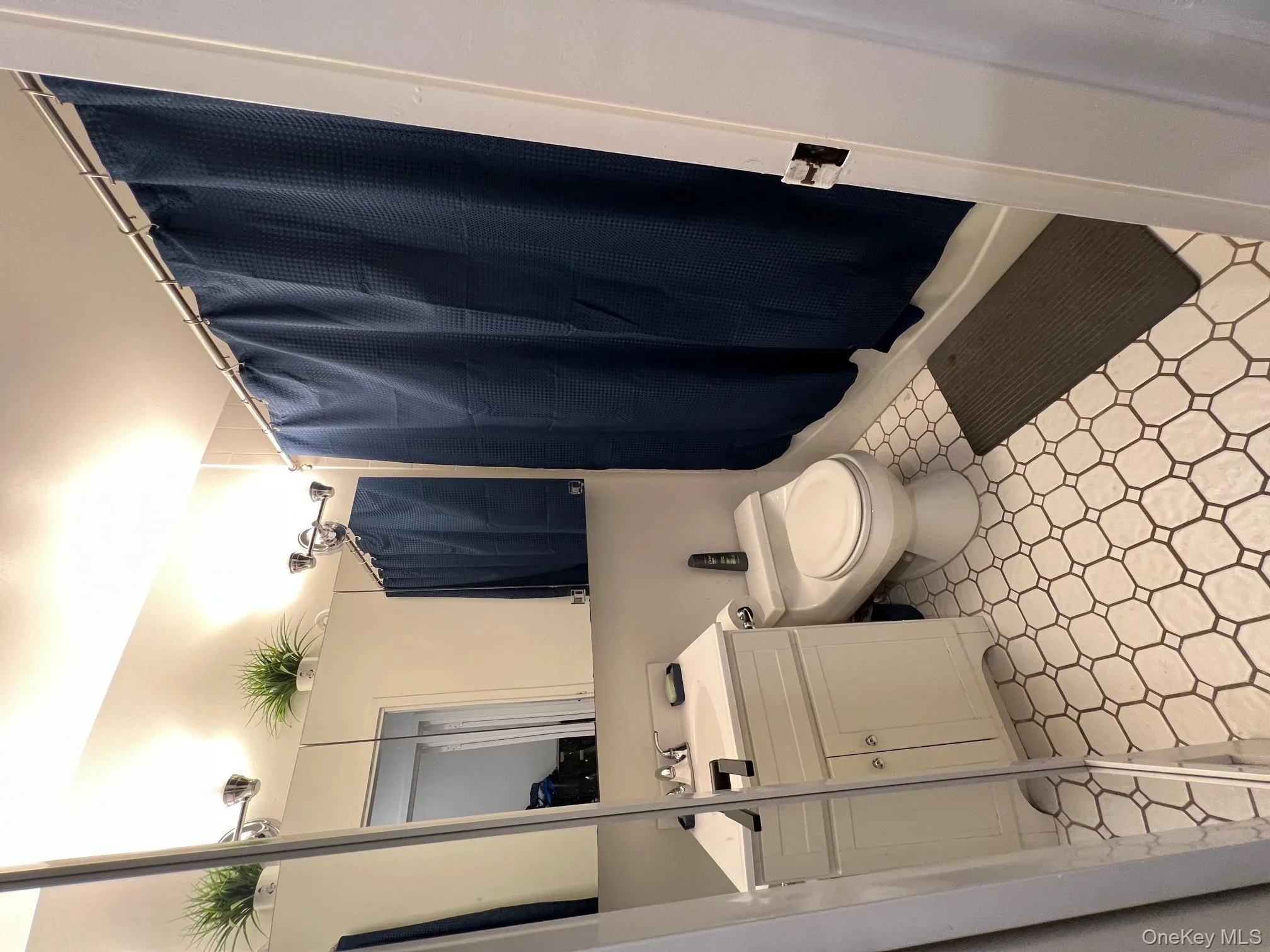 Full bathroom with a shower with shower curtain, vanity, and light floors Full bathroom with a shower with shower curtain, vanity, and light floors