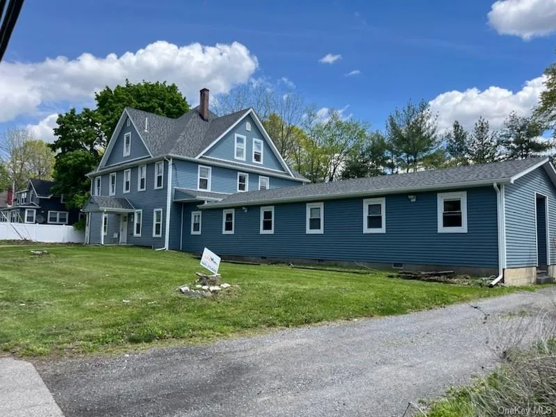 Rear view of property with a yard, roof with shingles, and a chimney Rear view of property with a yard, roof with shingles, and a chimney