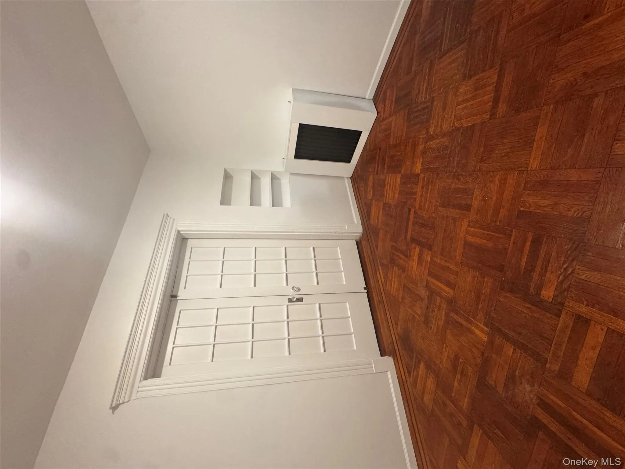 Unfurnished living room with baseboards and built in shelves Unfurnished living room with baseboards and built in shelves