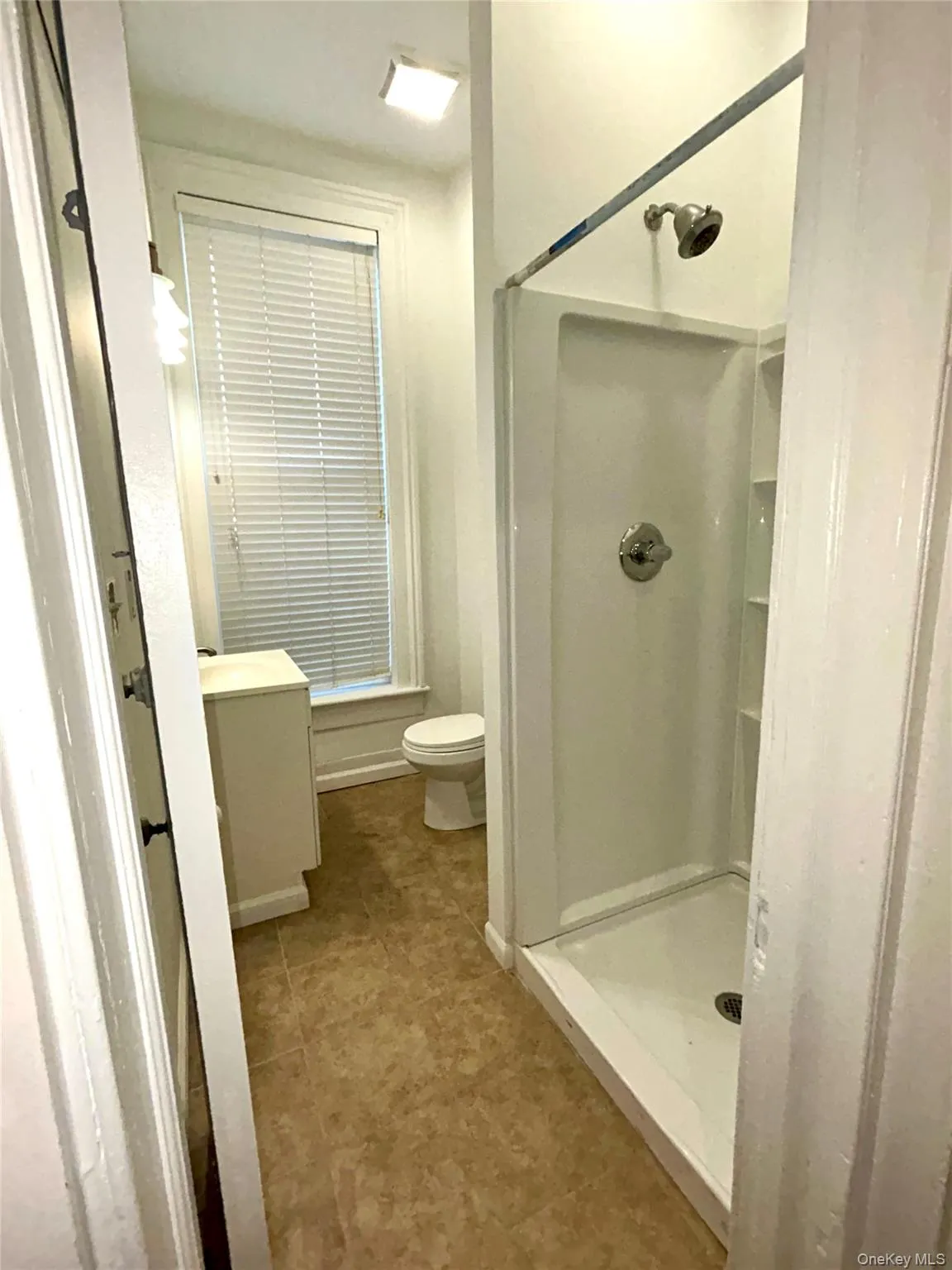 Bathroom with vanity and a shower stall Bathroom with vanity and a shower stall