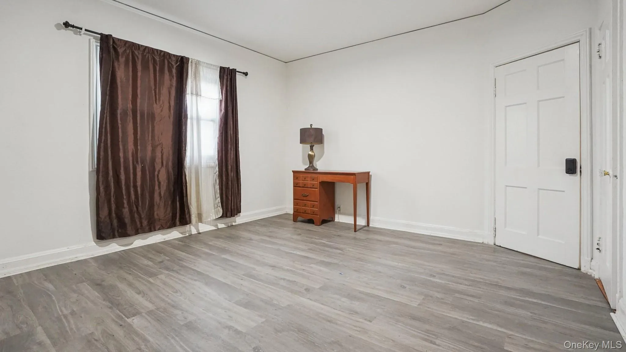 Unfurnished bedroom with light wood-type flooring and baseboards Unfurnished bedroom with light wood-type flooring and baseboards
