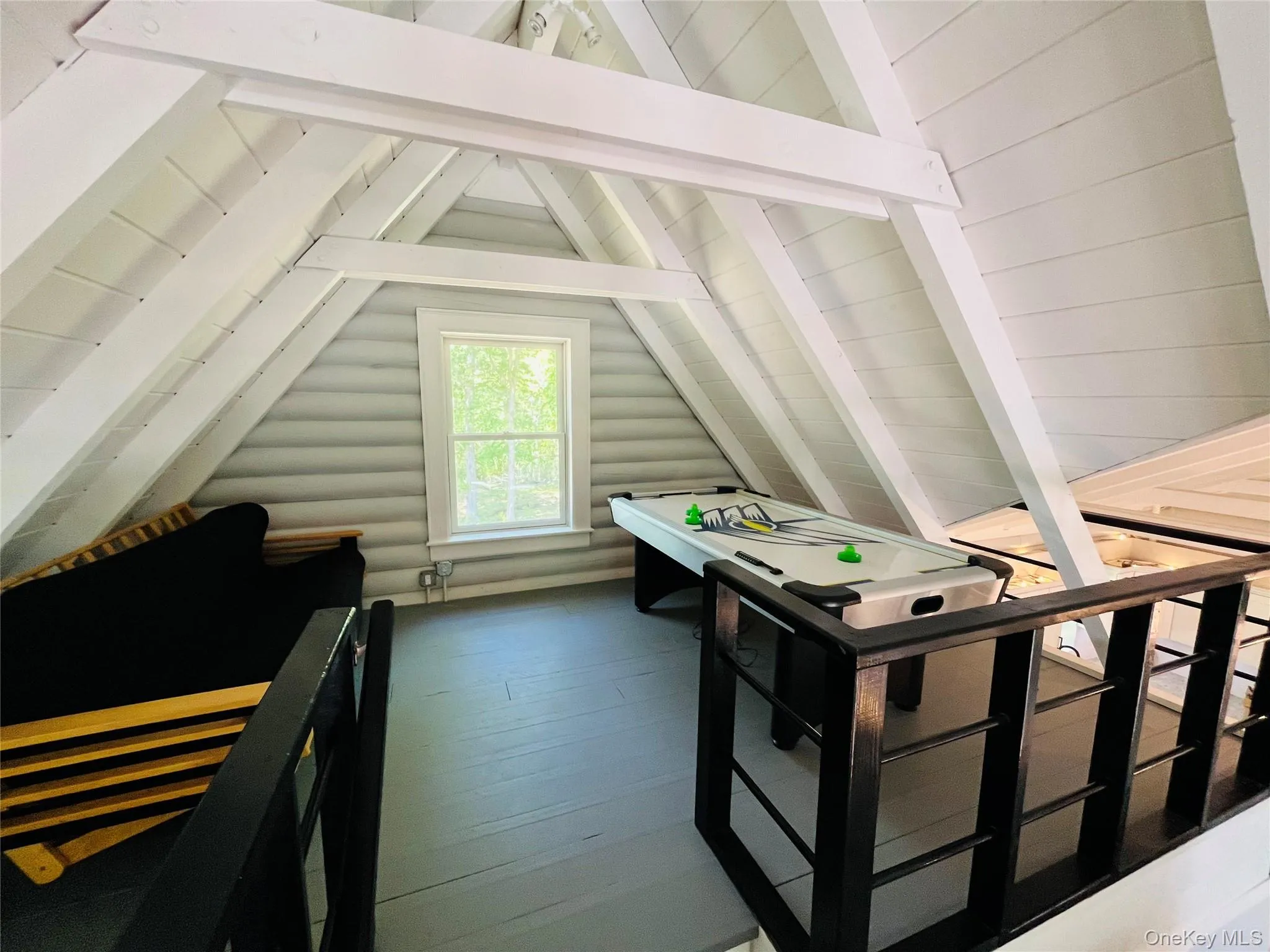 Recreation room featuring hardwood / wood-style flooring and rustic walls Recreation room featuring hardwood / wood-style flooring and rustic walls