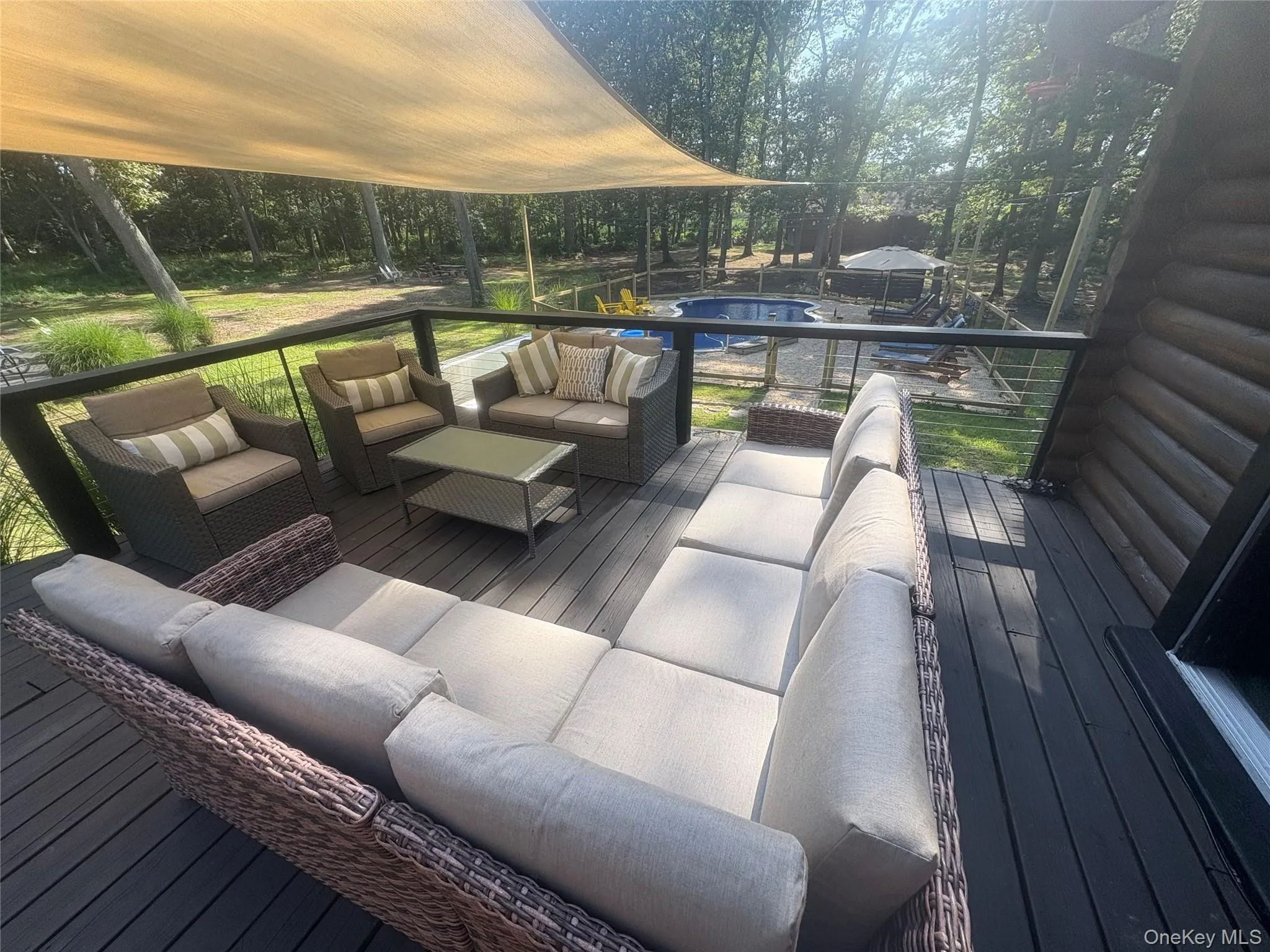 Wooden terrace featuring outdoor lounge area and an outdoor pool Wooden terrace featuring outdoor lounge area and an outdoor pool