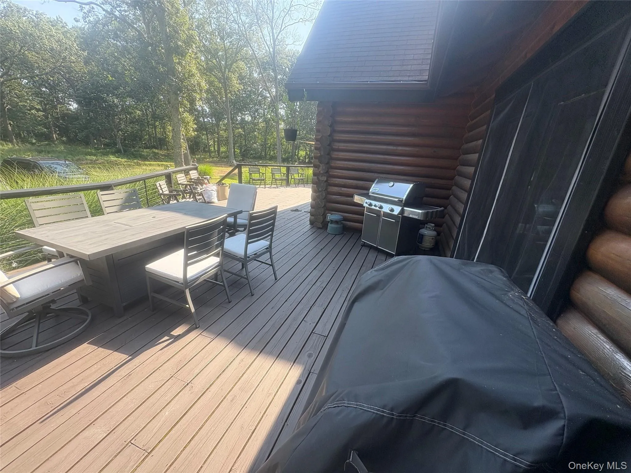 Deck featuring outdoor dining area and grilling area Deck featuring outdoor dining area and grilling area