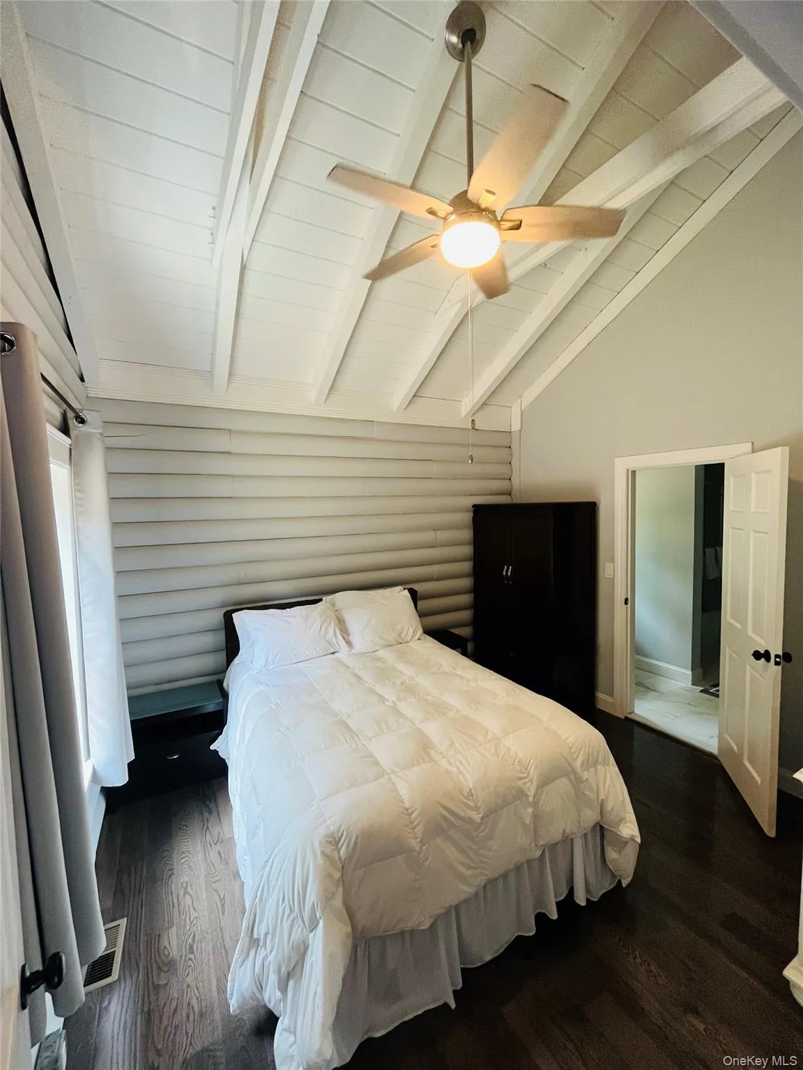 Bedroom featuring dark wood-style flooring and ceiling fan Bedroom featuring dark wood-style flooring and ceiling fan