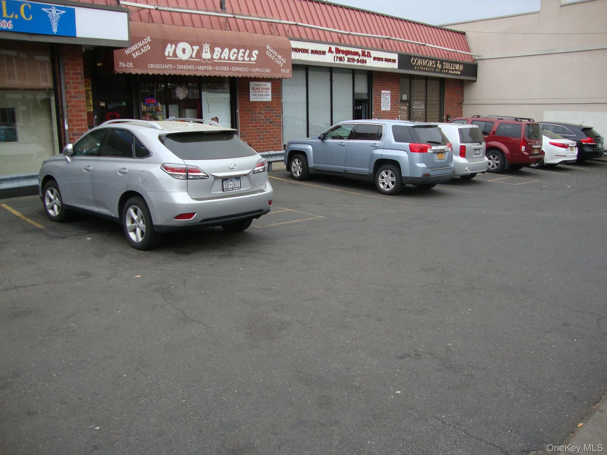 View of building exterior featuring uncovered parking View of building exterior featuring uncovered parking