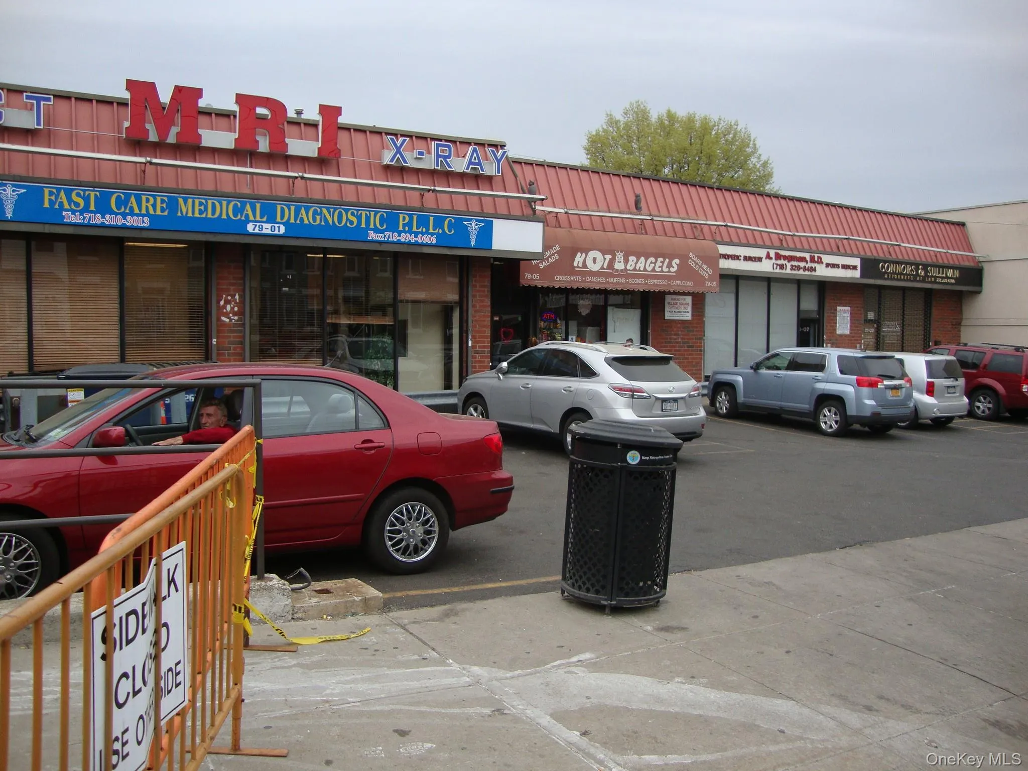 View of commercial property with uncovered parking View of commercial property with uncovered parking