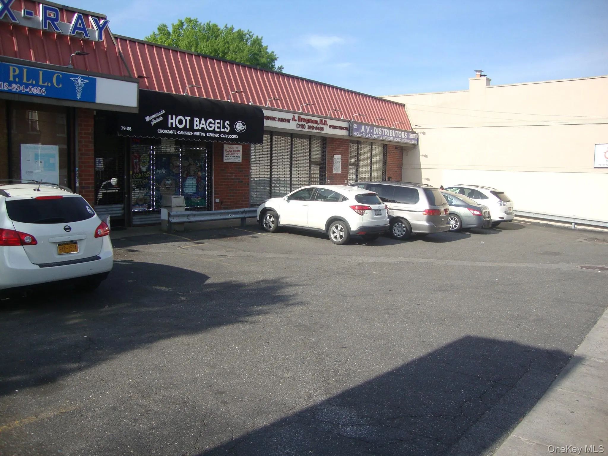 View of commercial property with uncovered parking View of commercial property with uncovered parking