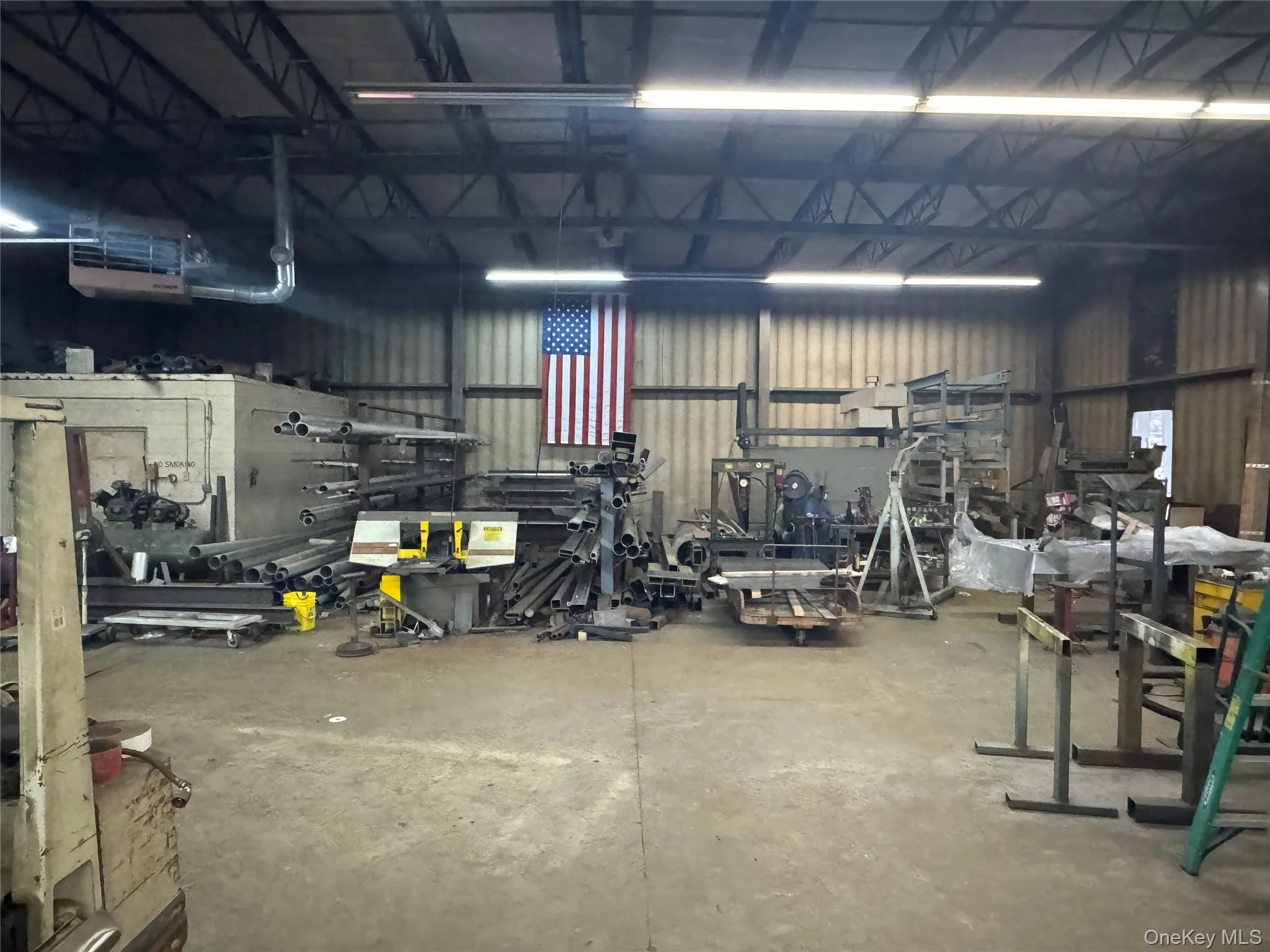 Garage featuring metal wall and a workshop area Garage featuring metal wall and a workshop area