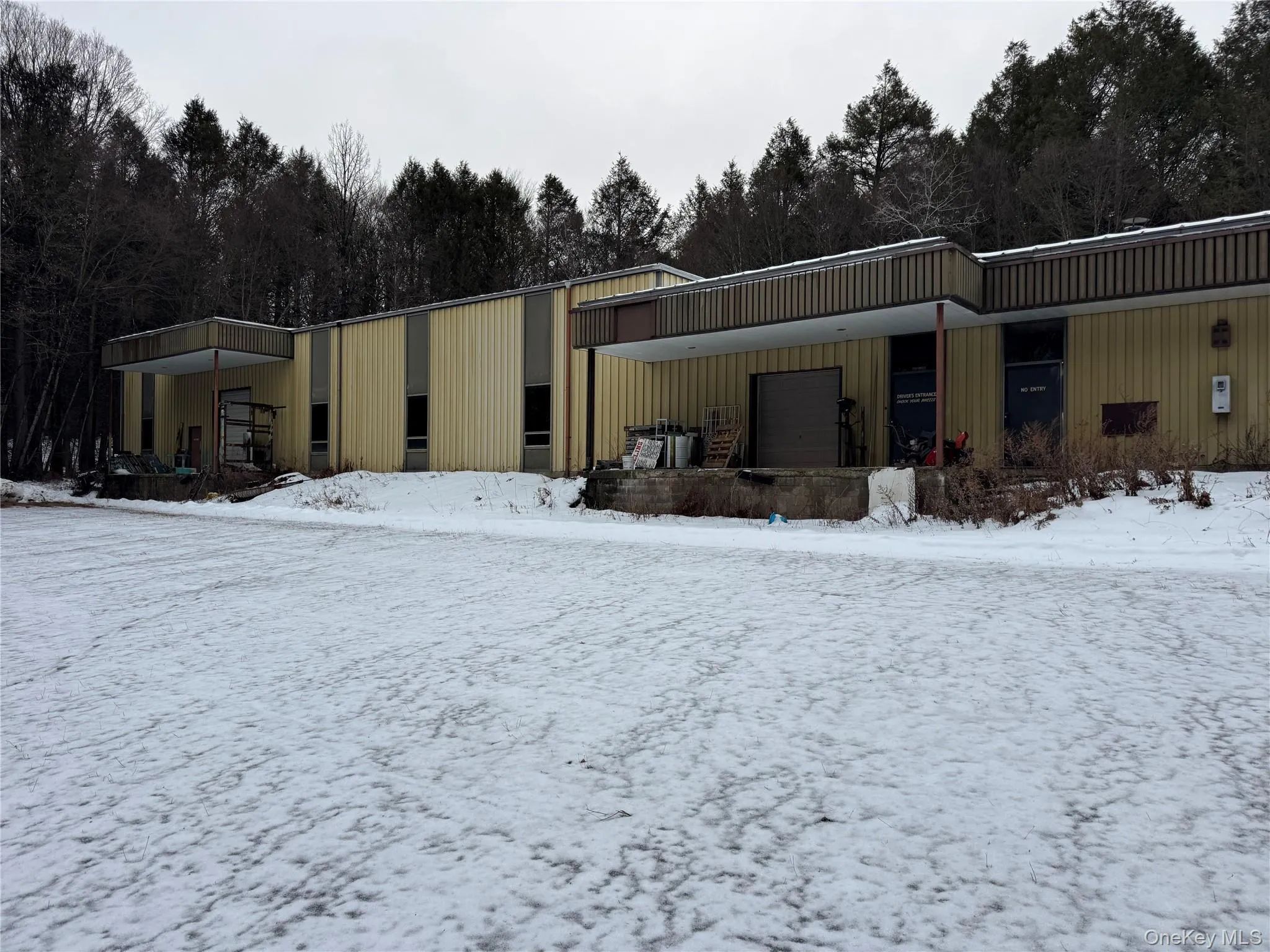 Snow covered building with an attached garage Snow covered building with an attached garage