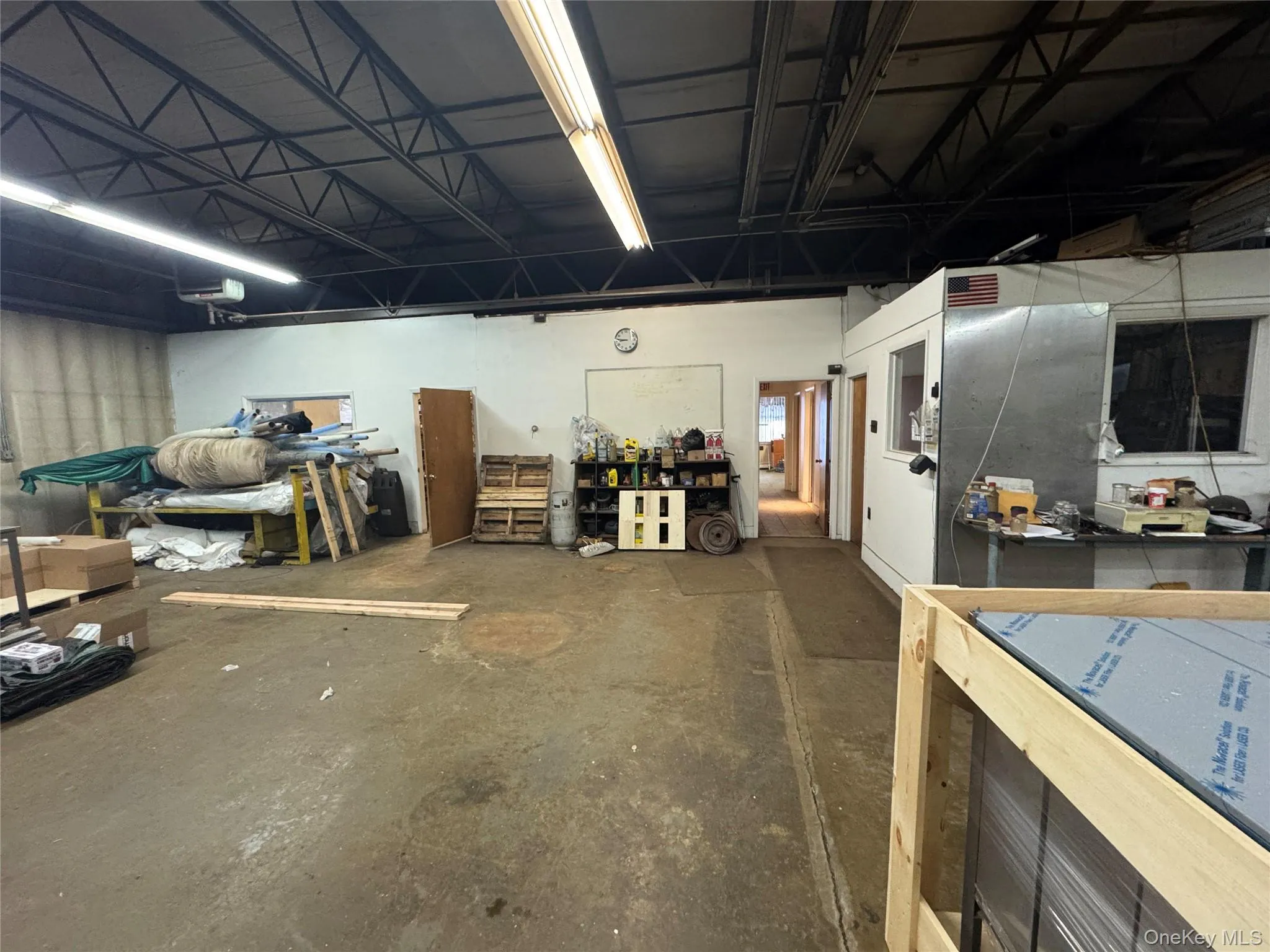 Misc room featuring a workshop area and a garage Misc room featuring a workshop area and a garage