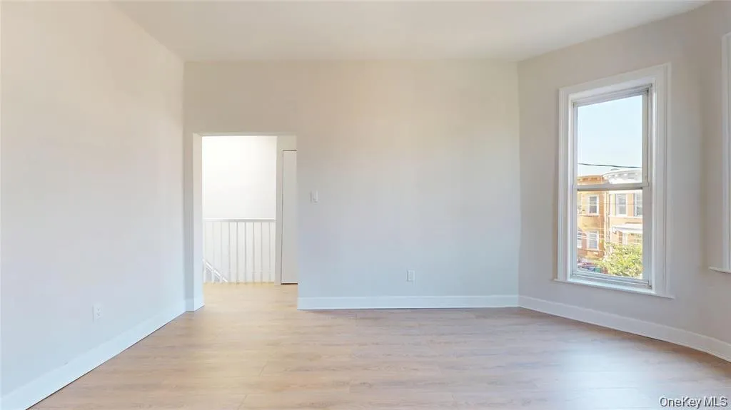 Spare room featuring light wood-type flooring and baseboards Spare room featuring light wood-type flooring and baseboards