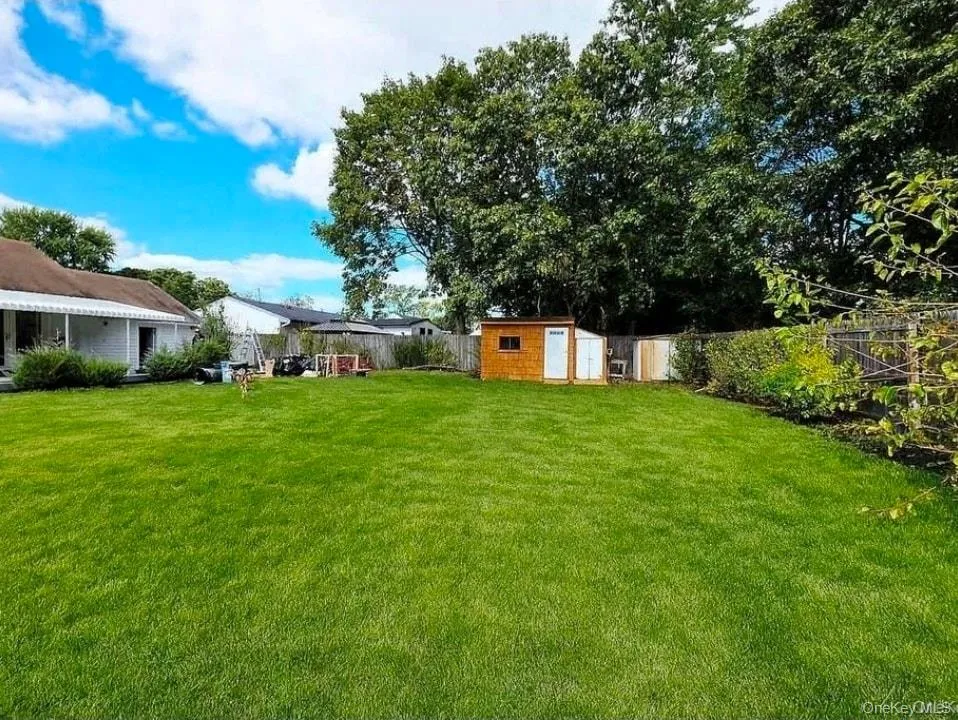 Fenced backyard with a shed Fenced backyard with a shed