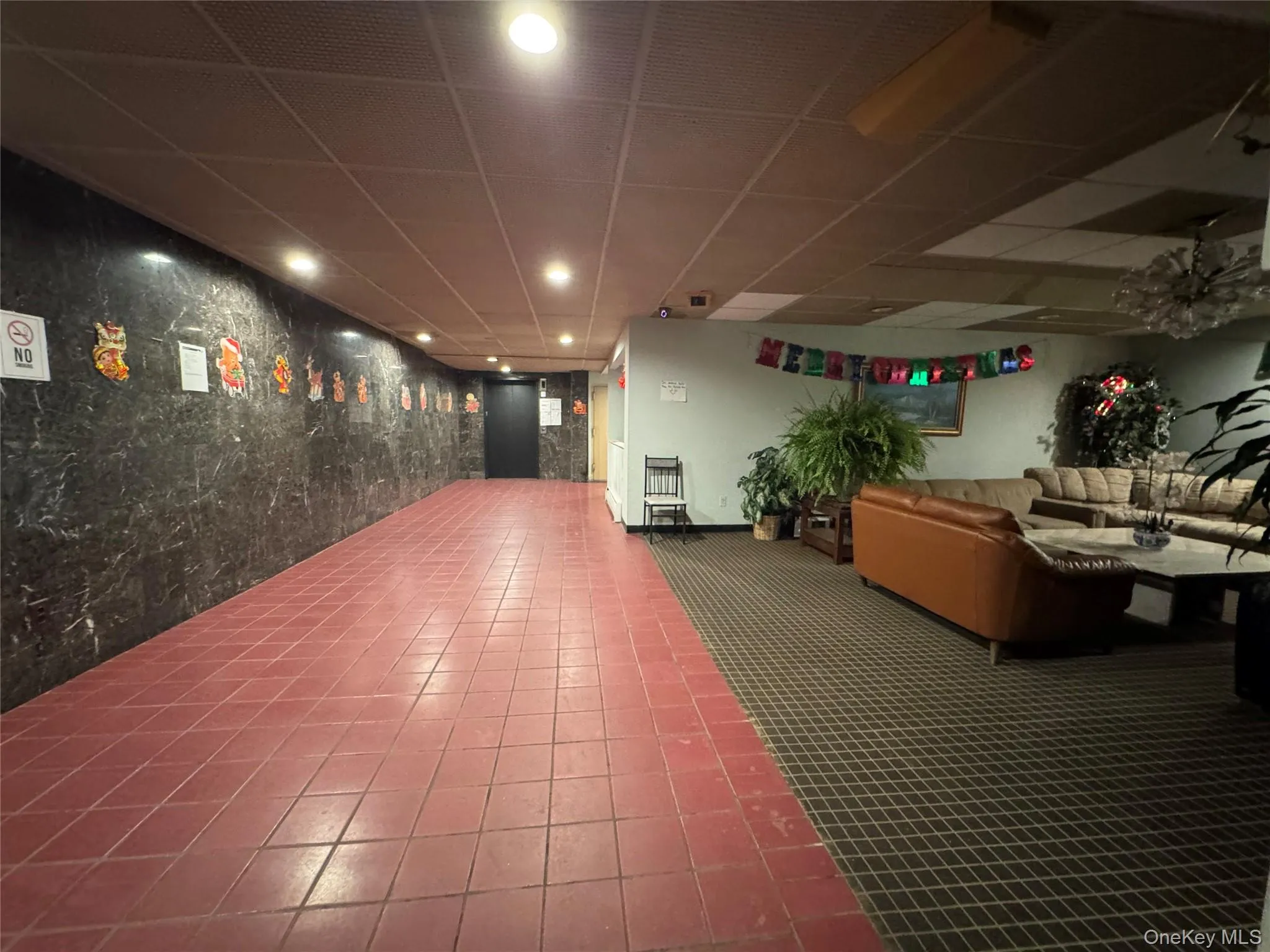 Building lobby featuring a drop ceiling, recessed lighting, and heating unit Building lobby featuring a drop ceiling, recessed lighting, and heating unit