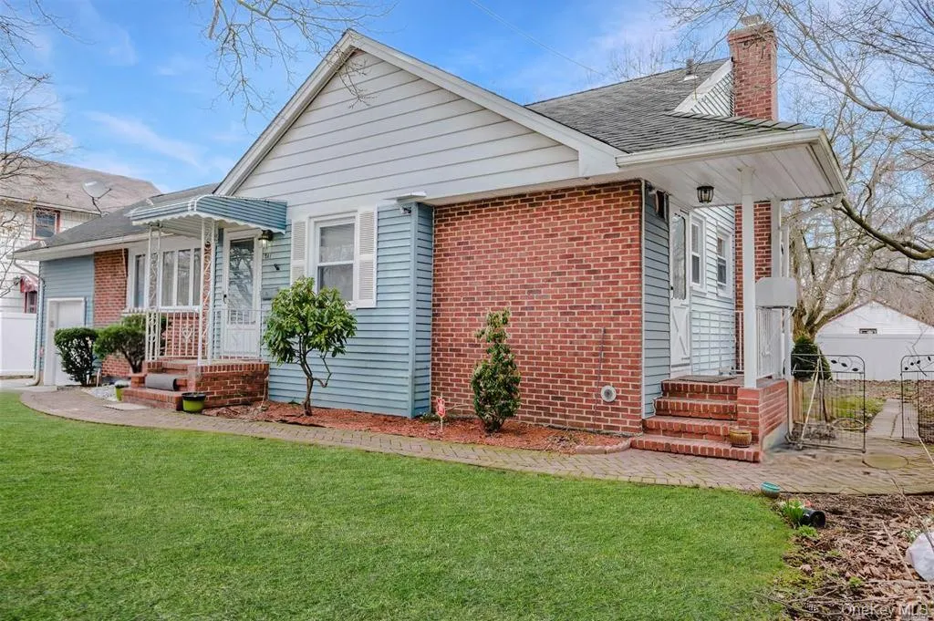 View of front of property featuring brick siding, a chimney, and roof with shingles View of front of property featuring brick siding, a chimney, and roof with shingles