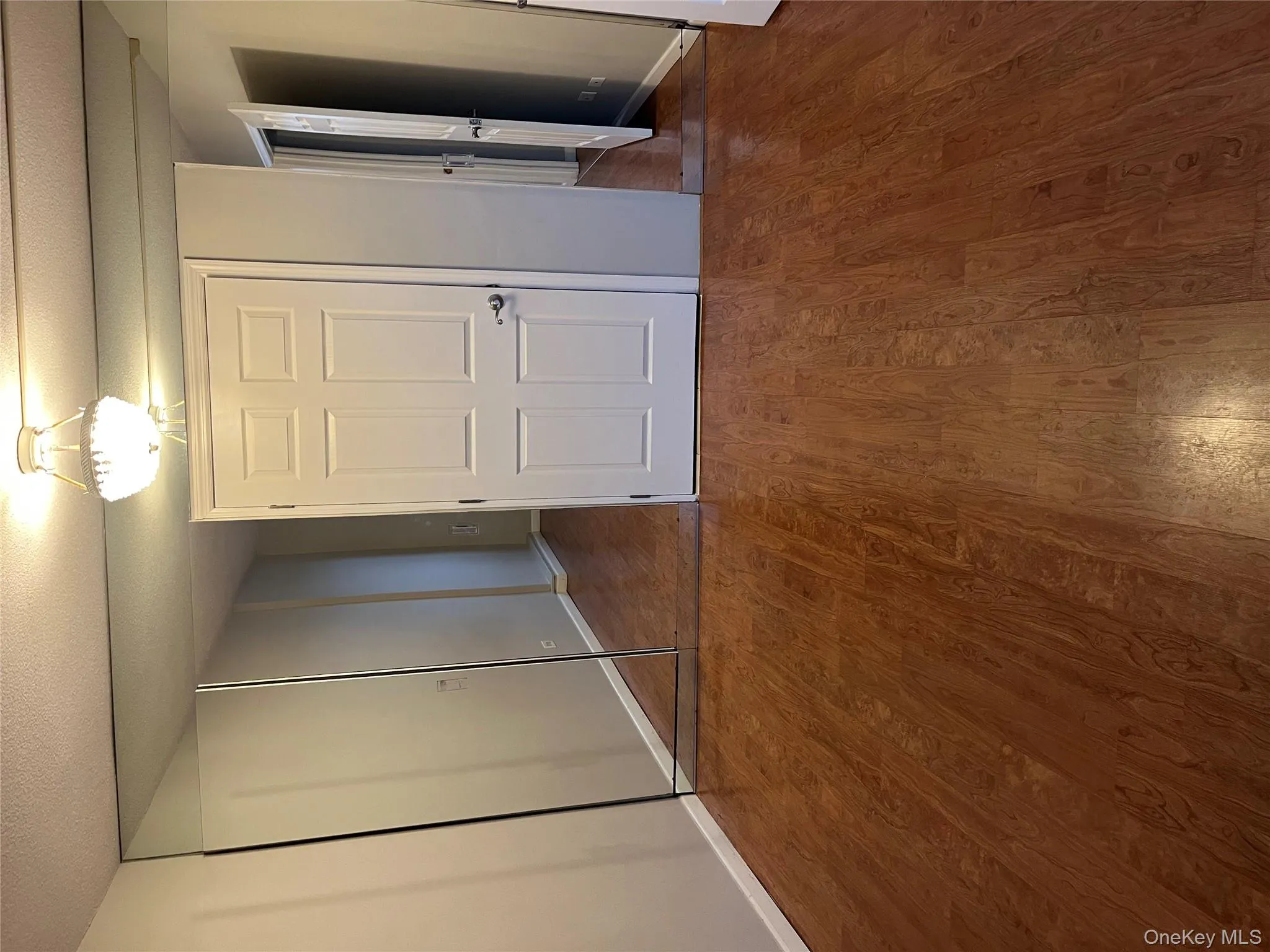 Unfurnished bedroom with a closet, a textured ceiling, and dark wood-style flooring Unfurnished bedroom with a closet, a textured ceiling, and dark wood-style flooring